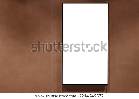 Mock up template. Vertical white blank signboard, media display, advertising billboard on brown wall inside shopping mall Royalty-Free Stock Photo #2214245577