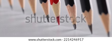 Sharp pencils in a row on a gray background