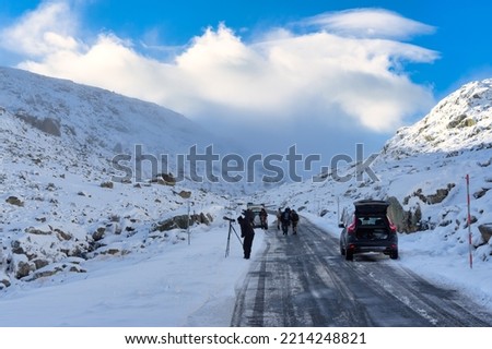 Sierra de Gredos, Spain, November 25 - 2021; several people take pictures of the snowy landscape.