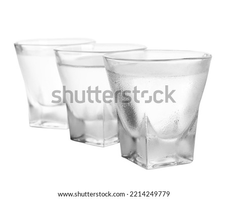 Vodka in shot glasses on white background