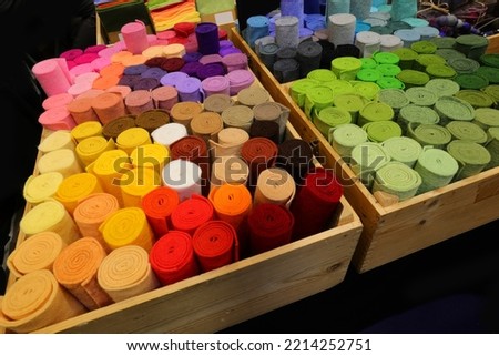 tubes of fabrics and colorful cloths and for sale in the cloth shop
