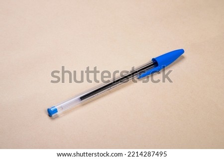 Blue Pen on a Beige Background Royalty-Free Stock Photo #2214287495