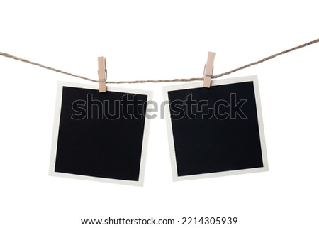 Clothespins with empty instant frames on string against white background. Space for text