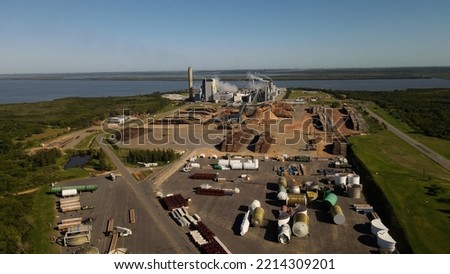 Smoking chimneys in paper mill factory and surrounding landscape, Fray Bentos in Uruguay. Aerial panoramic view Royalty-Free Stock Photo #2214309201