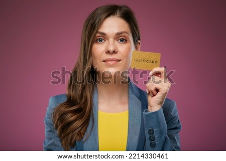 Smiling woman holding credit card. Isolated advertising portrait on pink back. 