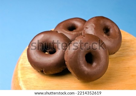 Very sweet dark chocolate mini donuts for snack. Royalty-Free Stock Photo #2214352619