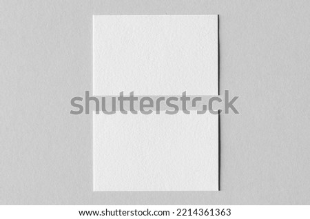 Textured business card mockup on a grey background.  85x55 mm.