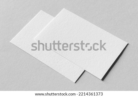 Textured business card mockup on a grey background.  85x55 mm.