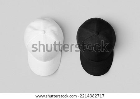 White and black baseball caps mockup, side by side. Royalty-Free Stock Photo #2214362717