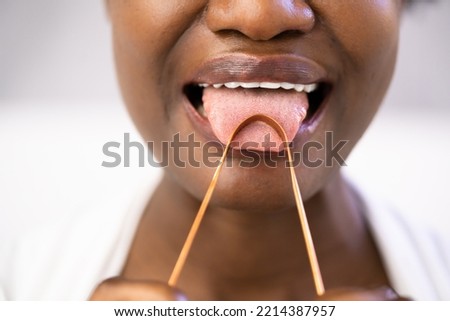 Bad Breath Tongue Scraper Or Brush Cleaner Royalty-Free Stock Photo #2214387957