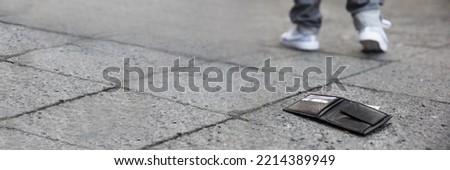 Man Lost Personal Wallet With Money On Street Royalty-Free Stock Photo #2214389949