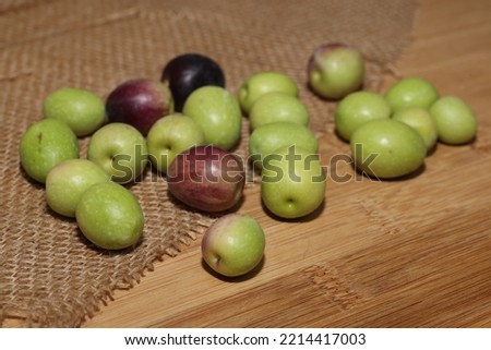 Olives and Olive Oil on wooden background