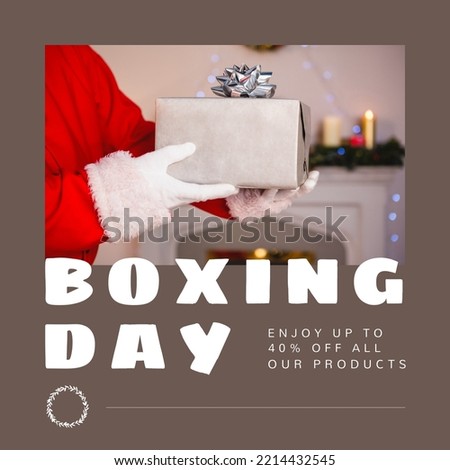 Composition of boxing day sales text over santa claus holding christmas present. Christmas, boxing day, sales, festivity, celebration and tradition concept digitally.