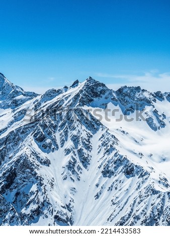 Beautiful landscape of snow-capped mountains. Royalty-Free Stock Photo #2214433583