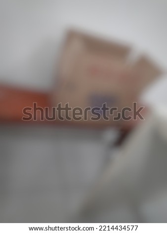 Defocused or blurred abstract background of a carton of mineral water placed on the wooden brown chair