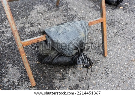 Sandbag used to weigh down a frame displaying a temporary road sign