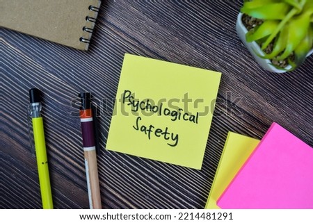 Concept of Psychological Safety write on sticky notes isolated on Wooden Table.
