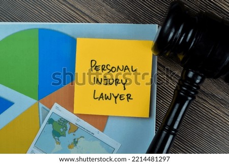 Concept of Personal Injury Lawyer write on sticky notes isolated on Wooden Table.