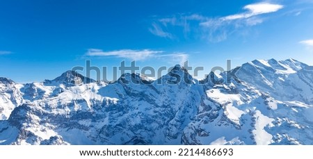 The beautiful view of snow-capped mountain peaks of  Swiss Mountain against the blue sky background Royalty-Free Stock Photo #2214486693