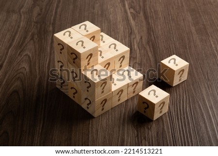 Question marks on wooden blocks, financial business concept