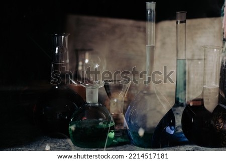Magic potions and ancient spell book Royalty-Free Stock Photo #2214517181