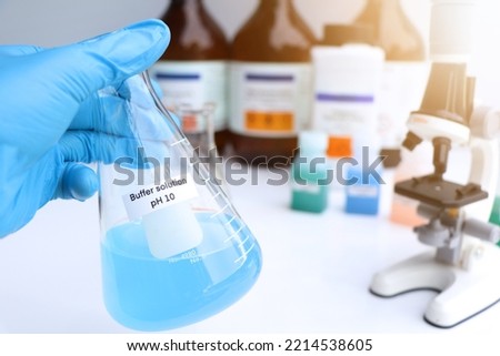 Buffer solution in glass, chemical in the laboratory and industry, Chemicals used in the analysis Royalty-Free Stock Photo #2214538605