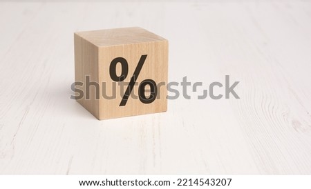 wooden cube with percent sign on white background. space for text