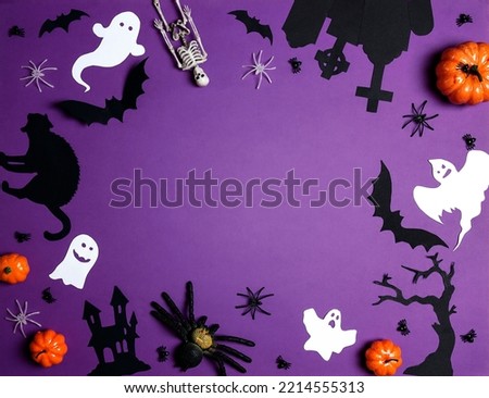Halloween frame of bats, spiders, pumpkins, ghosts and other scary on purple background. Flat lay, top view, copy space.