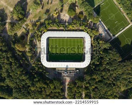 Soccer football stadium top down overhead Aerial in forrest park. Green grass landmark landscape architecture structure stands proffesional football club.