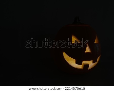 Halloween pumpkin glowing in the dark. The glowing eyes and mouth of a glow in the dark pumpkin.