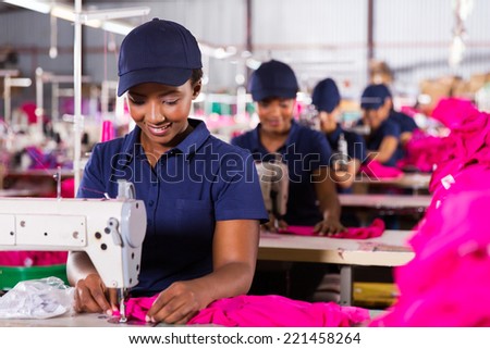 young african textile worker sewing on production line Royalty-Free Stock Photo #221458264