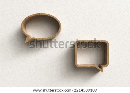 Wooden shelves in the shape of speech balloons on plaster wall. Royalty-Free Stock Photo #2214589109