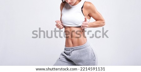 No name portrait. Young white fitness woman wearing sportswear standing over white wall background. Fitness concept. Mixed media Royalty-Free Stock Photo #2214591131