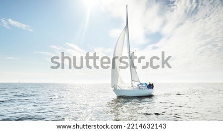 White sloop rigged yacht sailing in an open sea. Clear sky, cloudscape. A view from the sailboat. Transportation, travel, sport, recreation, leisure activity, racing, regatta. Panorama, copy space Royalty-Free Stock Photo #2214632143