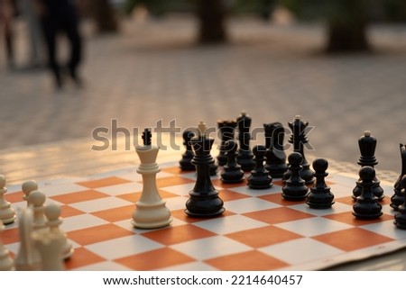 photo of  chess pieces on board during the sunset
