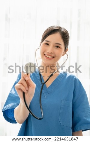 Professional woman doctor with assured expression, Smiling Asian Female doctor in blue medical uniform with stethoscope, Medical concept of healthcare workers
