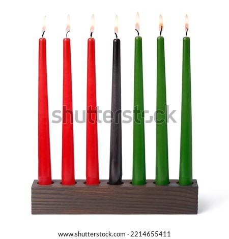 Kwanzaa festival concept with seven candles red, black and green in candlestick is isolated on white background