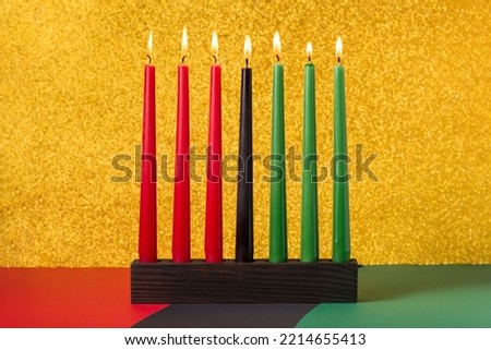 African American Kwanzaa holiday concept with traditional lit candles on symbolic background
