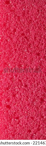close-up, background, texture, large long vertical banner. heterogeneous surface fine pore structure bright saturated red pumice stone for finger care. full depth of field. high resolution photo