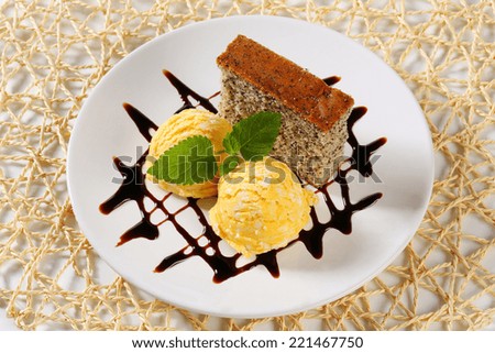 Piece of poppy seed cake with scoops of ice cream