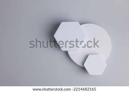 Scene for product presentation with space for text. Podiums of different geometric shapes on light grey background, top view