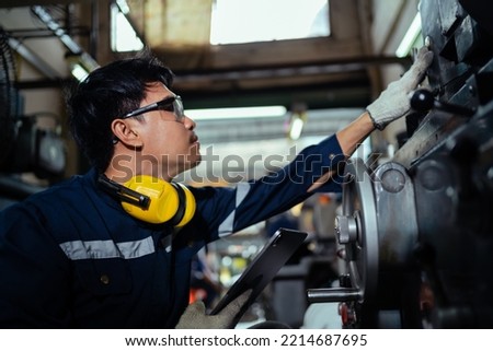 Asian male industrial worker working on machines. An industrial plant with a lot of equipment. industrial factory concept Machinery factory. banner image