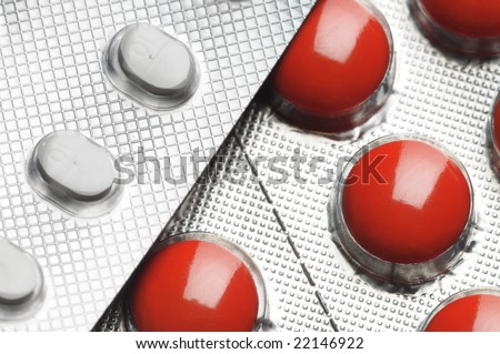 Red and white tablets. Close-up. Narrow depth of field.