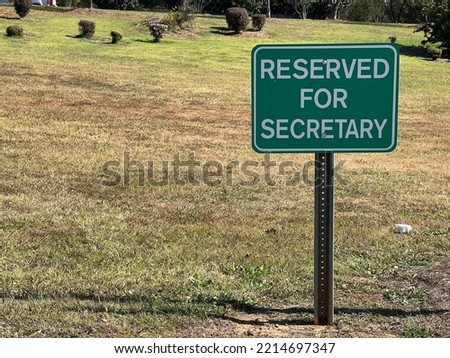 Reserved for secretary green parking sign at a school