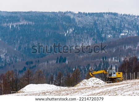 Construction machinery on the field in the mountains