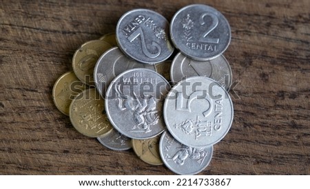 Various old Lithuanian coins isolated on wooden background.
