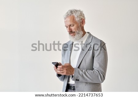 Older mature adult business man, senior middle aged old businessman professional wearing suit holding cell phone using smartphone mobile app online standing isolated on white background. Royalty-Free Stock Photo #2214737653