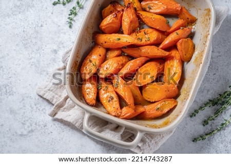 Honey coasted and glazed roasted carrots. Tasty and delicious vegetable side dish. Royalty-Free Stock Photo #2214743287