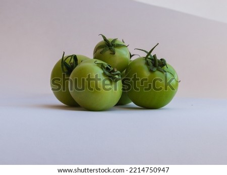 Green ripe tomatoes isolated on a white background.