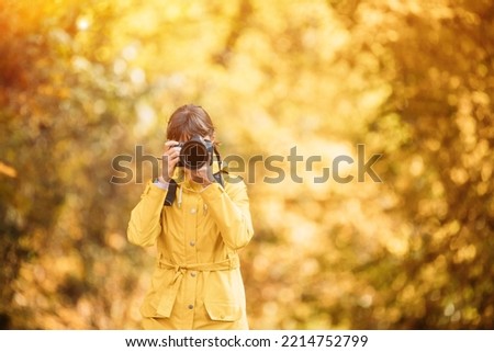 Young Pretty Caucasian Happy Smiling Girl Woman On Road In Autumn Forest. Tourist Woman Walking And Taking Photos In Forest. Fun Enjoy Outdoor Autumn Nature. Lady Photographed Nature.